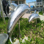 dolphins leaping garden ornament