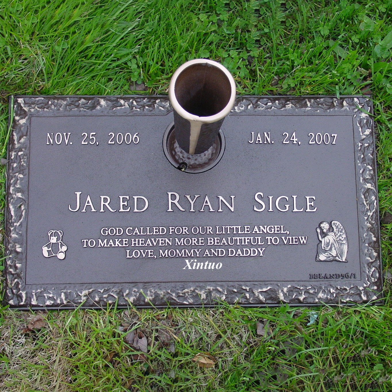 flat bronze headstone with vase