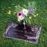 flat bronze headstone with vase