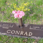 flat bronze headstone with vase