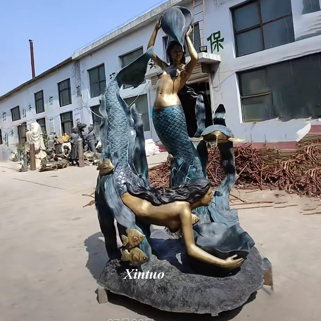 large outdoor mermaid statues