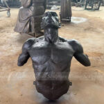 man coming out of the wall sculpture 3