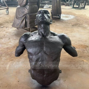 man coming out of the wall sculpture 3