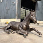 life size bronze horse statue reclining pose