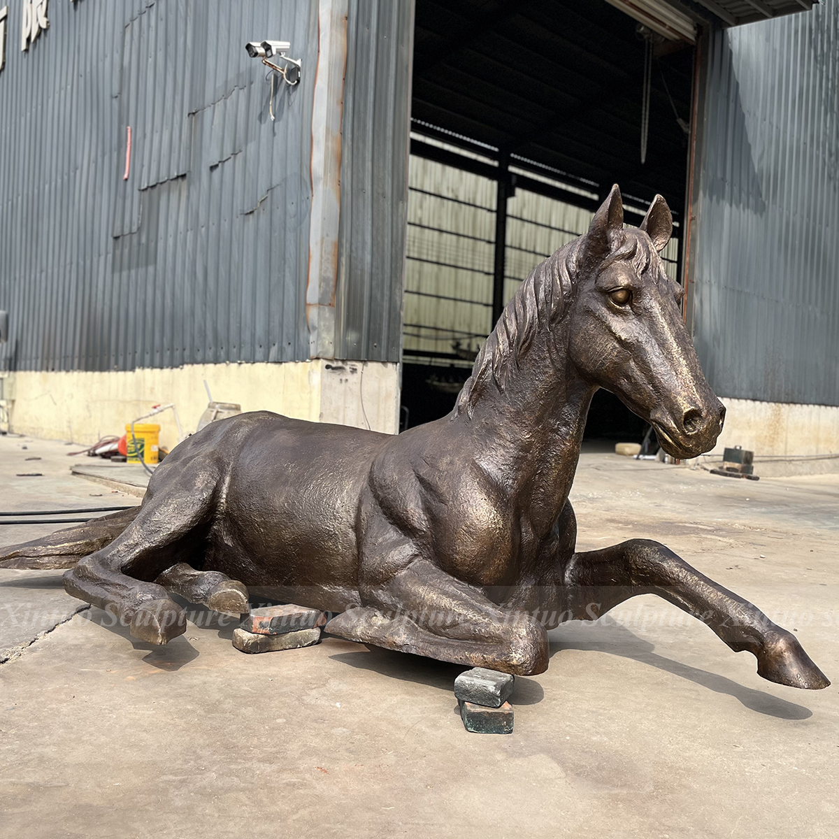 life size bronze horse statue reclining pose
