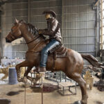 Bronze Cowboy Riding Horse Sculpture