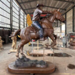 Bronze Cowboy Riding Horse Sculpture