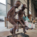 Children Playing Soccer Statue
